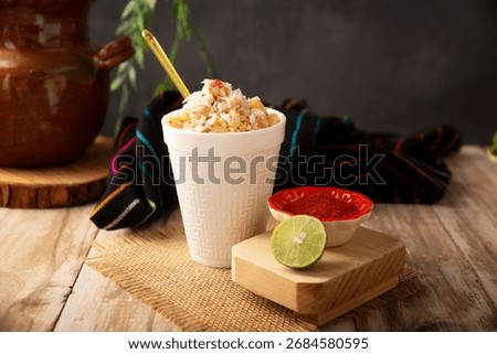Esquites. Corn kernels cooked and served with mayo, sour cream, lemon and chili powder, very popular street food in Mexico, also known as Elote en Vaso. The recipe varies depending on the region.