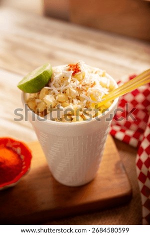 Esquites. Corn kernels cooked and served with mayo, sour cream, lemon and chili powder, very popular street food in Mexico, also known as Elote en Vaso. The recipe varies depending on the region.