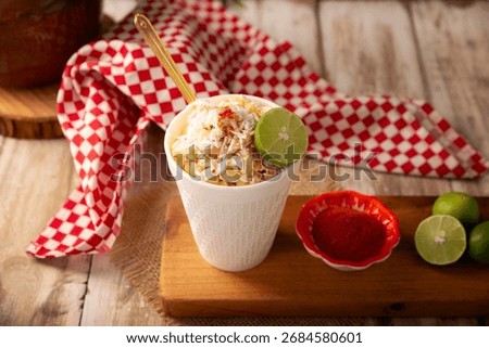 Esquites. Corn kernels cooked and served with mayo, sour cream, lemon and chili powder, very popular street food in Mexico, also known as Elote en Vaso. The recipe varies depending on the region.