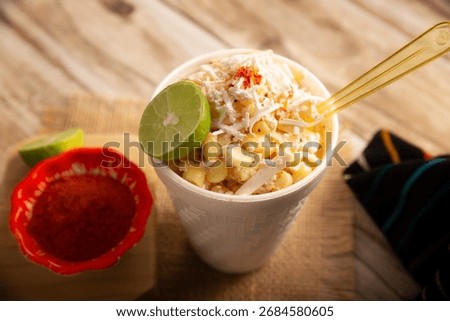 Esquites. Corn kernels cooked and served with mayo, sour cream, lemon and chili powder, very popular street food in Mexico, also known as Elote en Vaso. The recipe varies depending on the region.