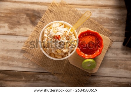 Esquites. Corn kernels cooked and served with mayo, sour cream, lemon and chili powder, very popular street food in Mexico, also known as Elote en Vaso. The recipe varies depending on the region.
