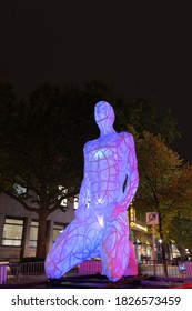 ESSEN, GERMANY - 2 OCTOBER 2020: Close-up View At Outdoor Lighting Installation Art With Male Sitting Sculpture For Festival Of Light At Radio Essen In Essen, Germany.