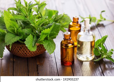 Essential aroma oil with peppermint  on wooden background. Selective focus, horizontal.