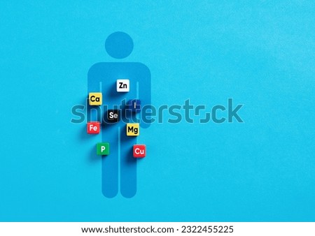 Essential minerals for body and health. Health care concept. Mineral symbols on colorful cubes over a human body symbol.