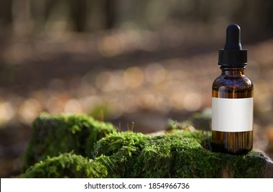 Essential oil for beard or aromatherapy in glass bottle  and man with. Copy space on bottle -  natural cosmetic concept. 