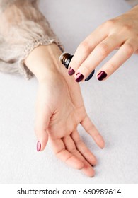 Essential oil bottle in womans hands