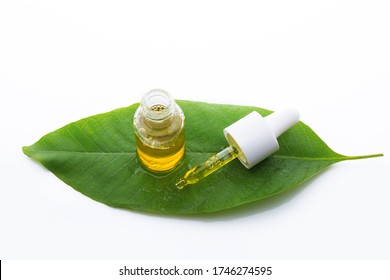 Essential Oil Dripping On A Green Leaf From A Pipette