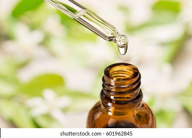 essential oil falling from glass dropper - Shutterstock ID 601962845