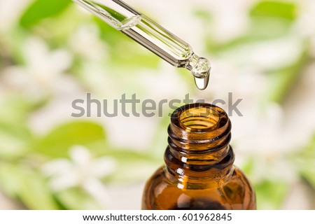 essential oil falling from glass dropper