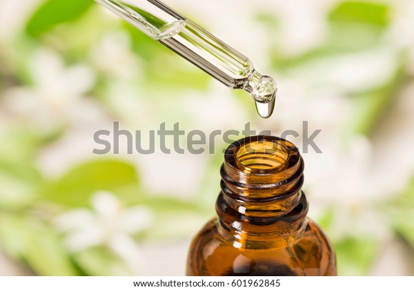 essential oil falling from\
glass dropper