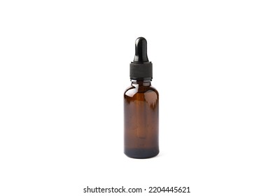 Essential Oil In A Glass Bottle With A Pipette. A Bottle Of Scented Oil. Isolated On A White Background. Essential Oil Mockup With Copy Space. Serum.