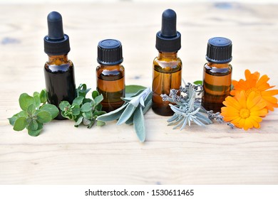 Essential Oil, Hydrosol, Extract In Brown Bottles With Fresh Herbs And Flowers, Herbal Medicine, Phytotherapy, Natural Remedies, Home Apothecary  Concept.