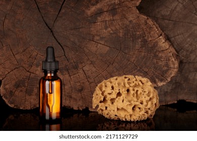 Essential Oil, Natural Face And Body Treatment. Mock-up, Healing Product And Natural Sponge, Dropper On Natural Background. Copy Space For Text, Old Wood Texture.