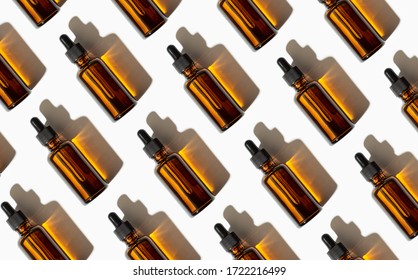 Essential oil or serum glass bottle pattern isolated on white background