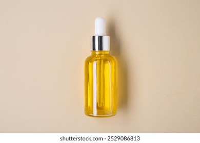 Essential oils in bottle on beige background, top view - Powered by Shutterstock