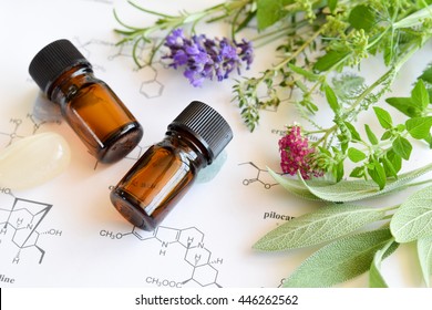 essential oils with herbs on science sheet