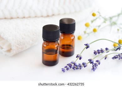 essential oils with herbs in white background