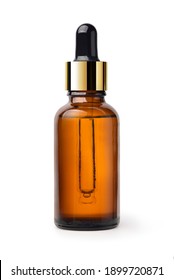 Essential serum oil in amber dropper bottle with gold cap isolate on white background. Clipping path.