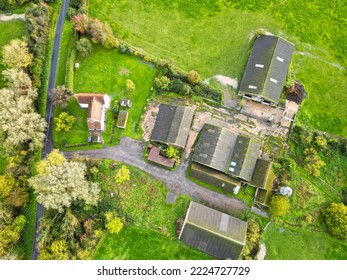 Essex, UK - Circa November 2022: Drone View Of An Old Farm House Seen In Lush Pasture. Adjacent Dairy Buildings And Barns Can Be Seen.