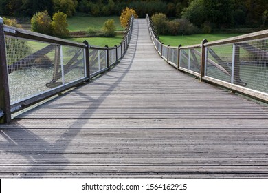 ESSING, BAVARIA / GERMANY - October 16, 2019: View on Tatzelwurm Brücke (bridge). Due to is curved architecture a tourist spot. Located in the Altmühltal. Wooden construction. Trees in the background.