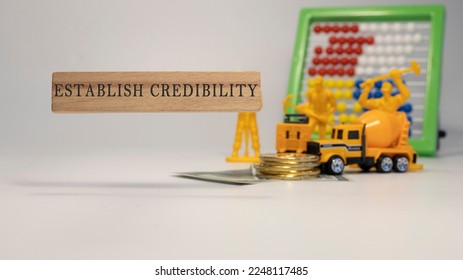 Establish Credibility text. It was taken in the studio written on a wooden frame. white background.