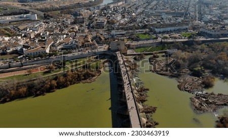 Establishing Aerial View Shot of The Roman bridge of Cordoba, a bridge in the Historic centre of Cordoba, Andalusia, southern Spain