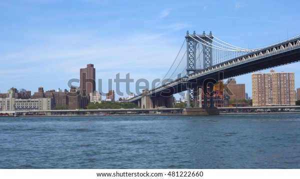 Establishing photo from Brooklyn of the\
Manhattan Bridge. Suspension structure for cars, subway and foot\
traffic over the east river. Toll free\
roadway.