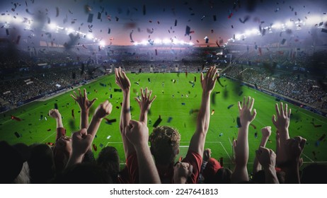 Establishing Shot of Fans Cheer for Their Team on a Stadium During Soccer Championship Final Match of Season. Team Scores Goal, Crowds of Fans Celebrate Victory with Confetti. Football Cup Tournament.