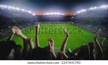 Establishing Shot of Fans Cheer for Their Favorite Team on a Stadium During Soccer Championship Final Match. Teams Play, Crowd of Fans Celebrate Victory and Goal. Football Cup Tournament.