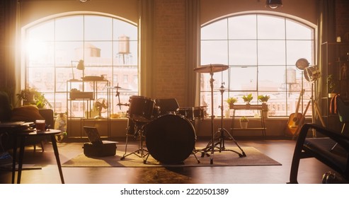 Establishing Shot: Music Rehearsal Studio in Loft Room with Drum Set in the Middle. Stylish Interior with Two Big Windows, Cozy Sofa, Shelves and Plants. Sunny Bright Day and Urban View. - Powered by Shutterstock