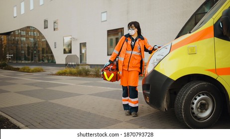 Establishing Shot: Paramedic Stands Near Ambulance. Writing On Clothes Means Urgent Care