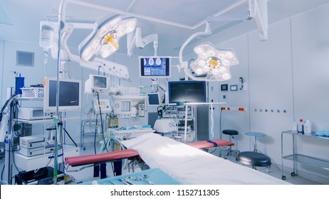 Establishing Shot of Technologically Advanced Operating Room with No People, Ready for Surgery. Real Modern Operating TheaterWith Working equipment,  Lights and Computers Ready for Surgeons.