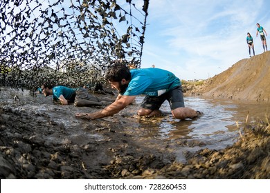 ESTARREJA, PORTUGAL - SEPTEMBER 23: Athletes crawling through mud at the Biorace on september 23, 2017 in Estarreja, Portugal. - Shutterstock ID 728260453
