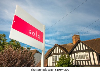 Estate Agency Sold Sign For A Traditional English Property. UK Real Estate Market Is A Prosper Business, A Huge Bubble That Could Pop In Any Moment. 