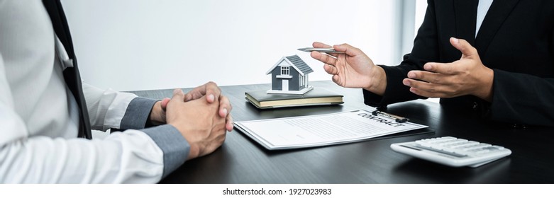 Estate agent broker presentating to client decision signing agreement contract real estate with approved mortgage application, buying mortgage loan offer for and house insurance.