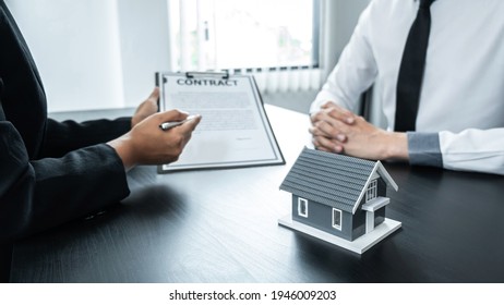 Estate agent broker presentating to client decision signing agreement contract real estate with approved mortgage application, buying mortgage loan offer for and house insurance.