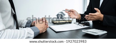 Estate agent broker presentating to client decision signing agreement contract real estate with approved mortgage application, buying mortgage loan offer for and house insurance.