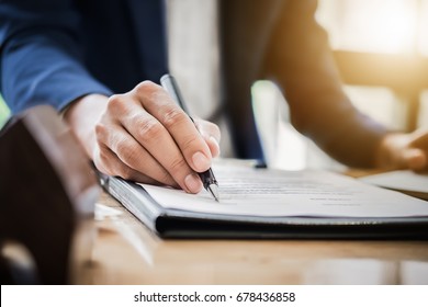 estate agent gives pen and documents agreement with customer to sign contract. Concept agreement