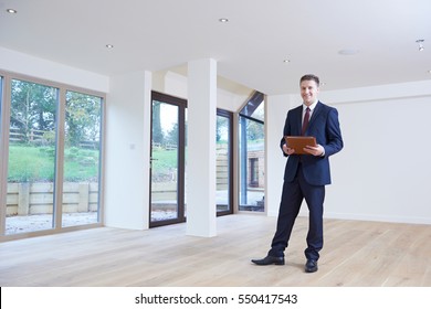 Estate Agent Looking Around Vacant Property For Valuation - Shutterstock ID 550417543