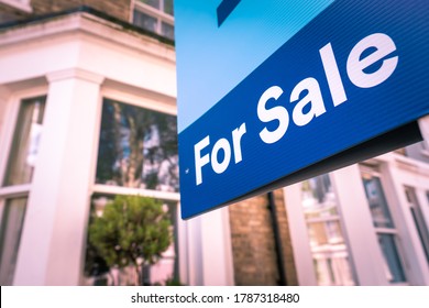 Estate agent For Sale sign on street of houses - Shutterstock ID 1787318480