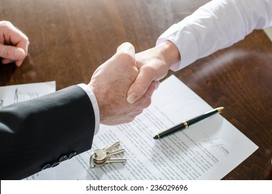 Estate agent shaking hands with his customer after contract signature - Shutterstock ID 236029696