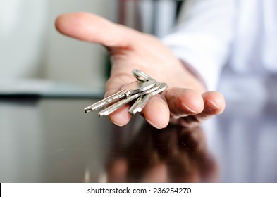 Estate Agent Showing House Keys On A Wooden Table