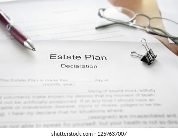 An Estate Plan document on a desk with glasses and pen                        