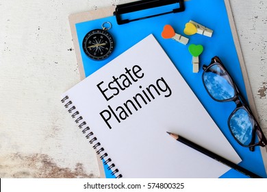 Estate Planning - Business concept top view notebook with pen and glasses on wooden table