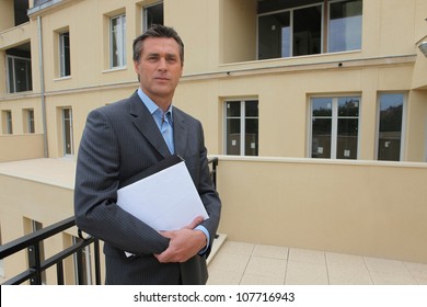 Estate-agent Stood Outside Property