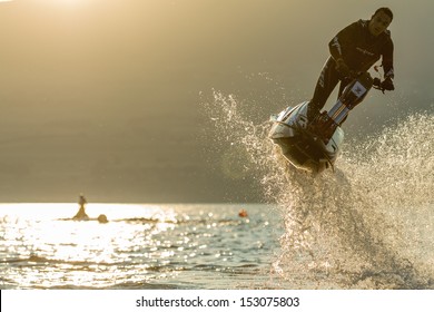 ESTAVAYER-LE-LAC, SWITZERLAND - JUL 06: Freestyle Jetski World Champion Seb Tchernia Performs A 180Ã?Â° Trick During The 2013 Swatch Free4style Competition On July 06, 2013 In Estavayer, Switzerland.