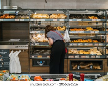 Estepona,Spain: September-25-2021. Caucasian and unrecognizable woman in Aldi supermarket picking up bread
