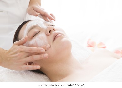 The Esthetician Applying Beauty Cream A Female Face