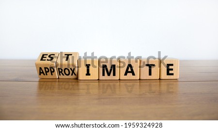 Estimate or approximate symbol. Turned wooden cubes and changed the word 'approximate' to 'estimate'. Beautiful wooden and white background, copy space. Business, estimate or approximate concept.