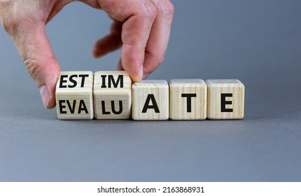 Estimate Or Evaluate Symbol. Businessman Turns Wooden Cubes And Changes The Word 'evaluate' To 'estimate'. Beautiful Grey Background, Copy Space. Business, Estimate Or Evaluate Concept.